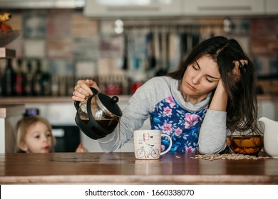Tired mother, trying to pour coffee in the morning. Woman lying on kitchen table after sleepless night, trying to drink coffee - Shutterstock ID 1660338070