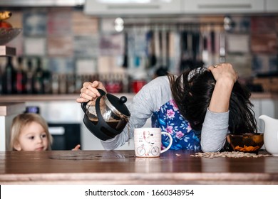 Tired mother, trying to pour coffee in the morning. Woman lying on kitchen table after sleepless night, trying to drink coffee - Shutterstock ID 1660348954