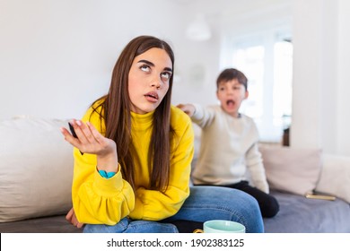 Tired Mother Trying To Work On A Laptop At Home During Her Kid Crying. Childcare And Working Mom Concept. Women Powerful. Toddler Tantrum. Young Lady Working At Home During Quarantine.