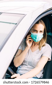 Tired Nurse Driving Home In Her Car From Night Shift Fighting Covid-19 Pandemic. Lifestyle Of Sad Girl Wearing Mask Looking Away.Coronavirus Pandemic Vertical Background With Copy Space. Lockdown Time