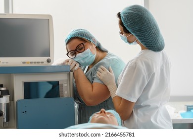 Tired Nurses After Difficult Operation Support Each Other In Operating Room