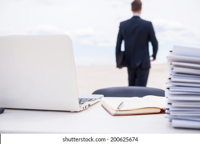 Tired of office life. Rear view of man in formalwear walking away from his working place