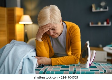 Tired Old Woman Front Of Ironing Board