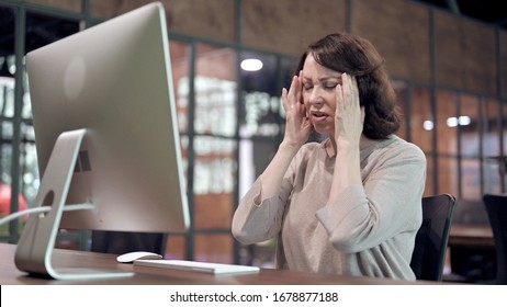 Tired Old Woman with Headache at Work, Pain in Head