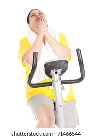 Tired Overweight, Fat Woman In Yellow Shirt On Stationary Fitness Bicycle