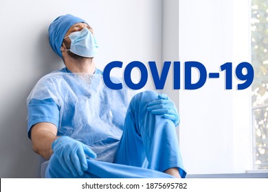 Tired Overwhelmed Doctor Sitting Near Wall In Hospital. Medical System Collapse During Coronavirus Pandemic