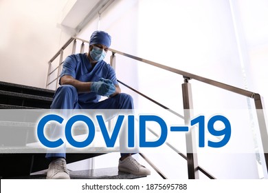 Tired Overwhelmed Doctor Sitting On Stairs In Hospital. Medical System Collapse During Coronavirus Pandemic