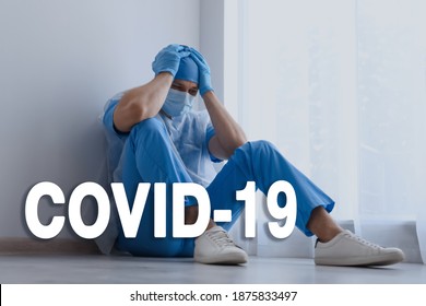 Tired Overwhelmed Doctor Sitting On Floor In Hospital. Medical System Collapse During Coronavirus Pandemic