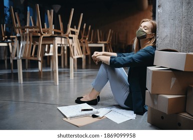 Tired owner sitting on floor in closed cafe, small business lockdown due to coronavirus. - Shutterstock ID 1869099958