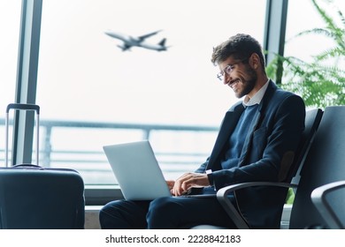 tired passenger using a laptop in the waiting room . - Shutterstock ID 2228842183