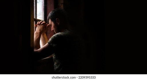 Tired pensive devote belief navy force young guy hero face cry hope hand pain love dark black old vintage retro home room text space. Worry human feel lost despair frown upset warfare believe concept - Shutterstock ID 2209395333