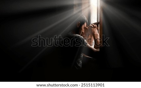 Tired pensive devote belief navy force young guy hero face cry hope hand pain love dark black old retro home room sun light text space Worry human feel lost despair frown upset warfare believe concept