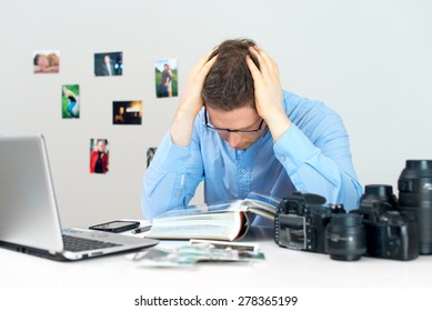 Tired Photographer Working At His Workplace.