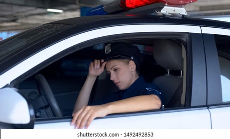 Tired Police Woman Adjusting Hat, Sitting In Squad Car, Exhausted Sub Work