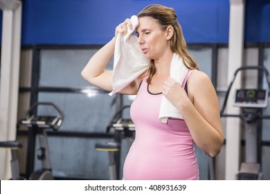 Tired Pregnant Woman Wiping Sweat With Towel At The Gym