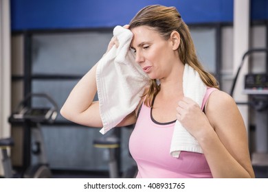 Tired Pregnant Woman Wiping Sweat With Towel At The Gym