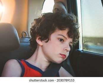 Tired Preschool Brunet Kid Boy In A T-shirt Sitting In Car During Traffic Jam. Sad Little School Child In Safety Car Seat With Belt Bored During Trip And Jorney. Safe Travel With Kids.