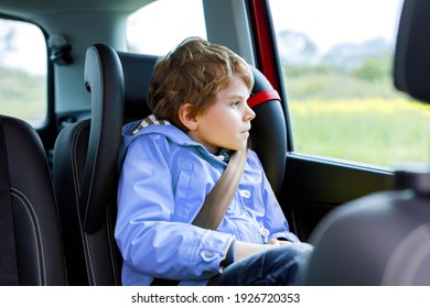 Tired Preschool Kid Boy Sitting In Car During Traffic Jam. Sad Little School Child In Safety Car Seat With Belt Enjoying Trip And Jorney. Safe Travel With Kids And Traffic Laws Concept