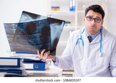 Tired Radiologist With X-ray Image In Hospital