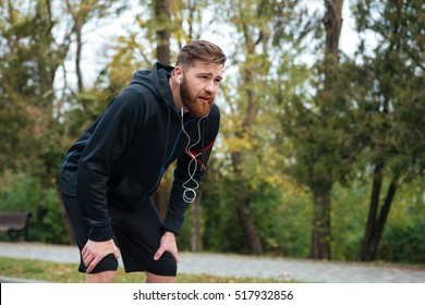 Tired Runner In Park. Side View