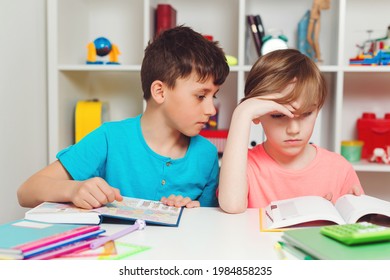 Tired Schoolchildren Are Reading Book At School. Sad School Boys Learning Lessons. Education And School Concept. Two Student Studying At School And Reading Books.