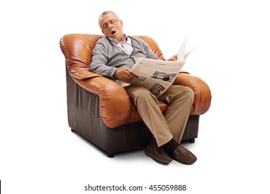 Tired senior gentleman holding a newspaper and sleeping seated on an armchair isolated on white background