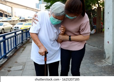 Tired senior woman wearing hygienic mask walk outdoor on street sidewalk in city,feel sick,vertigo,nauseous,allergy to dust,pollution,smog,PM2.5,air contamination,elderly people inhaling toxic fumes - Powered by Shutterstock