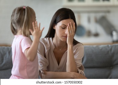 Tired Single Mother Feel Stressed Desperate About Screaming Stubborn Kid Daughter Tantrum, Frustrated Depressed Young Adult Mom Annoyed By Naughty Difficult Rebellious Child Girl Problems Concept