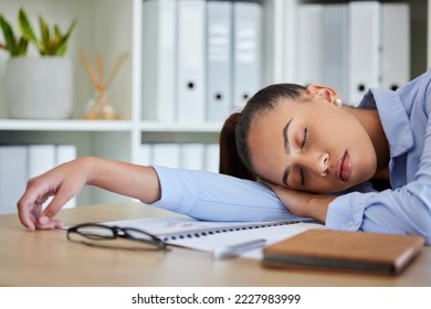 Tired, sleep and woman in business on her table feeling burnout and overworked while sleeping in her office. Nap, dreaming and exhausted with fatigue businesswoman napping on her table at work - Shutterstock ID 2227983999