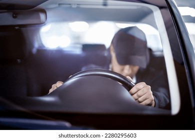Tired and sleepy driver. Drowsy man driving car. Person sleeping in traffic. Accident or crash. Drunk person, alcohol law violation, DUI. Dangerous irresponsible travel at night. Exhausted fatigue guy
