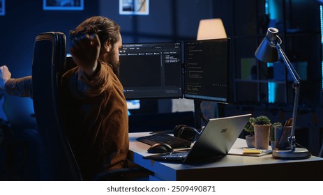 Tired software engineer taking break from coding, removing headphones, rubbing eyes, feeling exhausted. Drowsy IT admin drained by project overdue deadline, pausing tasks to rest - Powered by Shutterstock