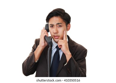 Tired and stressed Asian businessman 
