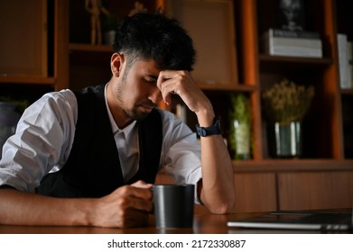 Tired And Stressed Asian Businessman Or Male CEO In The Office, Upset And Worried About His Company Business Turnover.