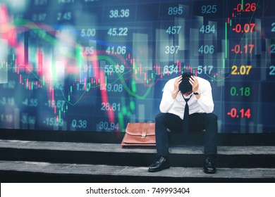 Tired or stressed businessman sitting on the walkway in panic digital stock market financial background - Powered by Shutterstock