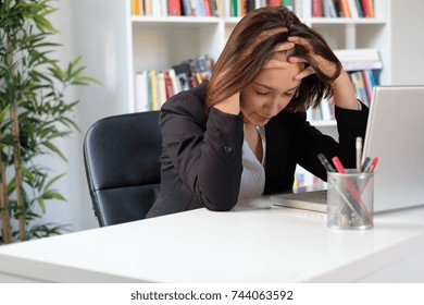 Tired And Stressed Employee At Work Sitting In The Office