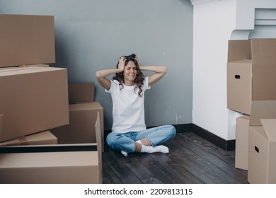 Tired Stressed Girl Holding Her Head Sitting With Cardboard Boxes, Having Problem With Relocation. Hispanic Female Suffers Stress On Moving Day. Eviction, Financial Trouble, Divorce Concept.