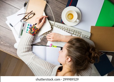 tired student girl with books and coffee sleeping on the table. education, session, exams and school concept . studying hard. Top view - Powered by Shutterstock