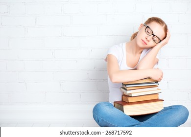 tired student girl in glasses asleep hugging books