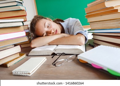 Tired student lies and sleep on the books. Photo of young girl in school. Back to school!