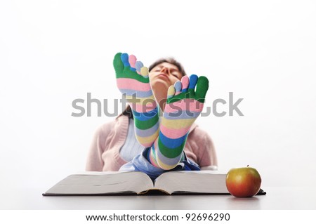 Tired of studies,  student relaxing  with his feet up on his desk, similar pictures on my portfolio