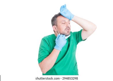 Tired Surgeon Doctor Removing Mask To Breath