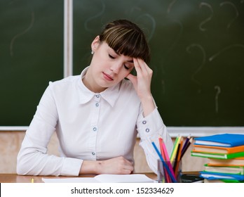 Tired Teacher In Classroom