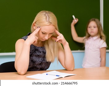 Tired Teacher In Classroom