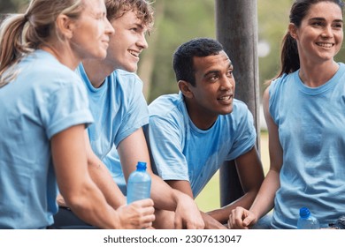 Tired team resting and drinking water at boot camp - Powered by Shutterstock