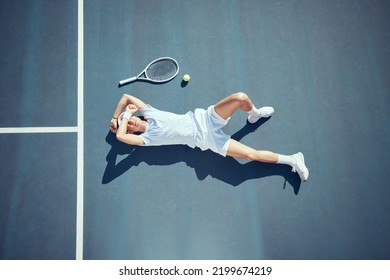 Tired tennis sports loser man on floor with racket, ball and court in summer sun from above. Relax and fitness player lying on ground, resting or taking break after match, game or outdoor practice - Powered by Shutterstock