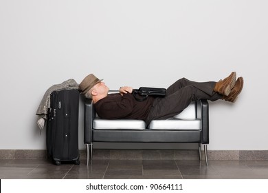 Tired Tourist In Anticipation Of Landing On Aircraft (ferry, Train Or Bus). Flight Delay Due To Weather Conditions. Waiting Hall.