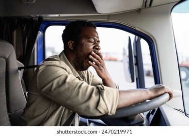 Tired truck driver feeling sleepy and yawning while driving. - Powered by Shutterstock