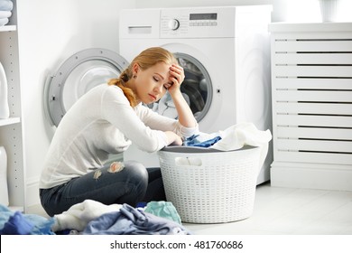 Tired Unhappy Woman Housewife Is Engaged In The Laundry, Fold Clothes Into The Washing Machine