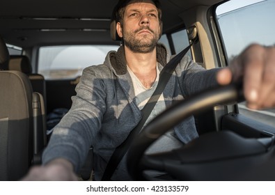 Tired Unshaven Man Is Driving The Car