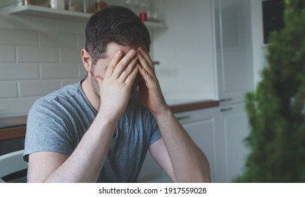 Tired Upset Man Sitting In The Kitchen.